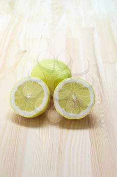 fresh lemon  over kitchen pinewood table closeup