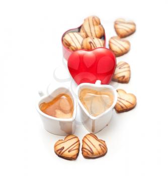 heart shaped cream cookies on red heart metal box and couple of espresso coffee cups