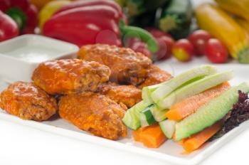 classic  buffalo chicken wings served with fresh pinzimonio and vegetables on background,MORE DELICIOUS FOOD ON PORTFOLIO