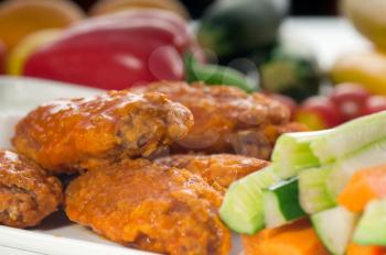 classic  buffalo chicken wings served with fresh pinzimonio and vegetables on background,MORE DELICIOUS FOOD ON PORTFOLIO