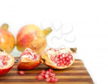 fresh pomegranate fruit on  wood over white background