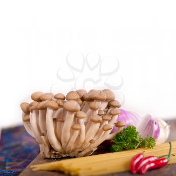 Italian pasta and mushroom sauce raw ingredients over rustic old wood