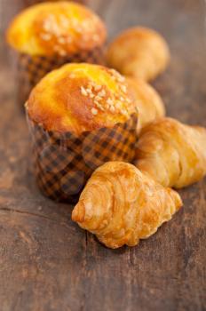 fresh baked muffin  and croissant mignon on old wood table