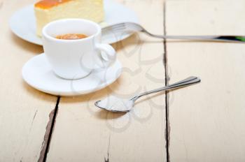 italian espresso coffee and cheese cake over white wood table