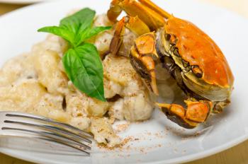 fresh homemade Italian gnocchi with seafood sauce crab and basil