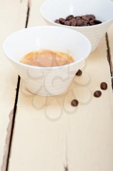italian espresso cofee and beans on a white wood table 