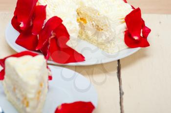whipped cream mango cake with red rose petals 