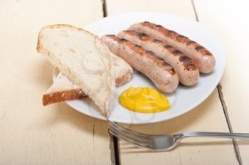 traditional fresh German wurstel sausages grilled with yellow mustard 
