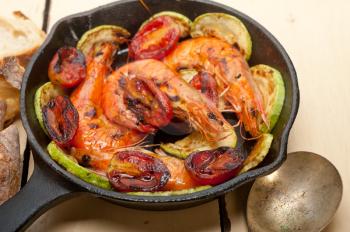 roasted shrimps on cast iron skillet  with zucchini and tomatoes