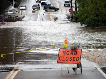 Royalty Free Photo of A Flooded Road And A Road Closed Sign