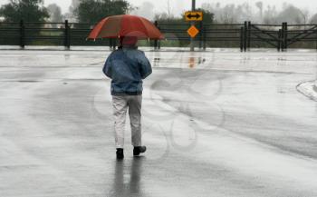 Royalty Free Photo of a Person Walking in the Rain