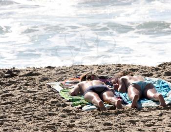 Royalty Free Photo of Two Women Tanning on the Beach
