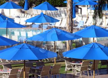 Royalty Free Photo of Umbrellas at a Resort Pool