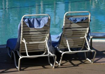 Royalty Free Photo of Beach Chairs by the Pool