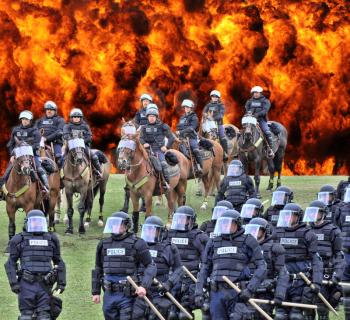 Royalty Free Photo of Moving toward trouble - Members of the SDPD (San Diego Police Department) riot control unit on foot and horseback more towards the trouble.