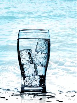 Royalty Free Photo of a Glass of Water in the Ocean