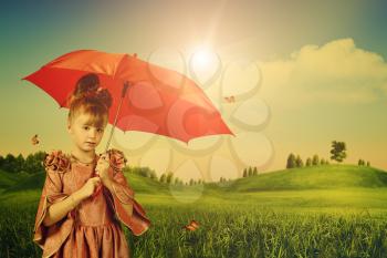 Royalty Free Photo of a Little Girl With an Umbrella in a Summer Meadow