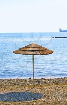 Royalty Free Photo of an Umbrella on the Beach at the Mediterranean Sea