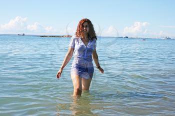 Royalty Free Photo of a Woman Walking in the Sea