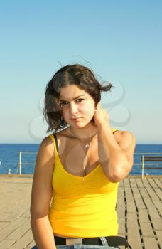 Royalty Free Photo of a Woman Sitting on a Pier