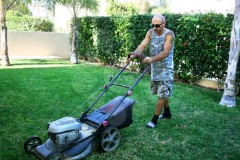 Royalty Free Photo of a Man Cutting the Grass