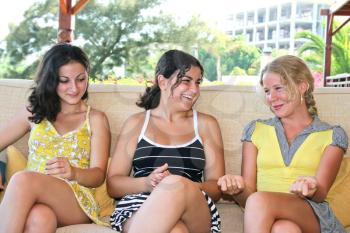 Royalty Free Photo of Three Girls Sitting Together