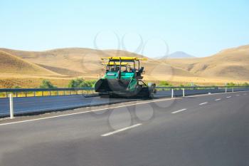 Royalty Free Photo of an Asphalt Paving Machine on a Mountain Road in Turkey