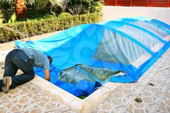 Royalty Free Photo of a Man Preparing a Swimming Pool For Winter