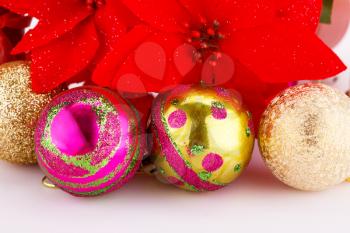 Christmas colorful balls with holly berry flowers closeup image.
