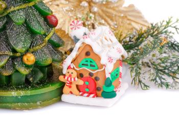 Fir tree candle, toy house and holly berry flower on white background.