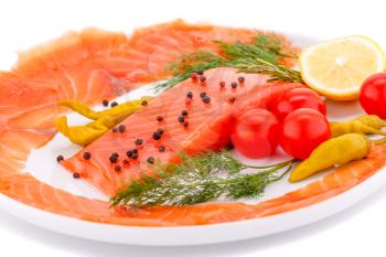 Salmon fillet with lemon, dil, pepper on plate isolated on white background.
