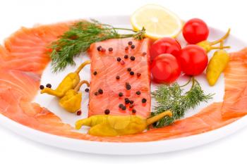 Salmon fillet with lemon, dill, pepper on plate isolated on white background.
