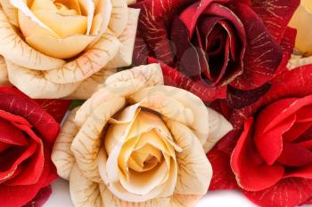 Red and yellow fabric roses closeup picture.