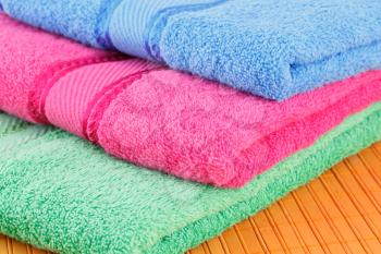 Colorful folded towels closeup picture.