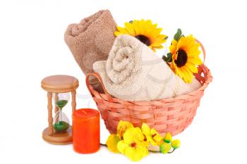 Spa set with towels, sandglass, candle and flowers isolated on white background.