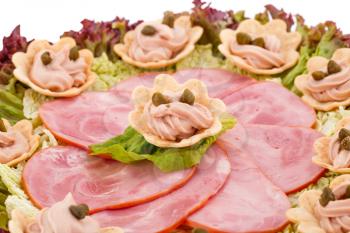 Fish cream and  capers in pastries, ham and lettuce on plate.