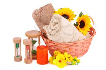 Spa set with towels, sandglasses, candle and flowers isolated on white background.