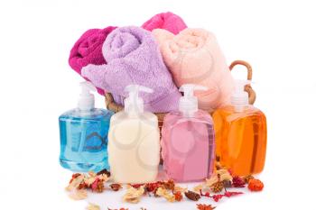 Spa set with towels, liquid soaps and dried flower isolated on white background.