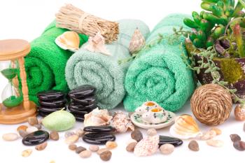 Spa set with towels, candles, shells, plants and stones isolated on white background.