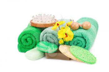 Spa set with towels, soaps, sponges, massagers and orchid flowers isolated on white background.