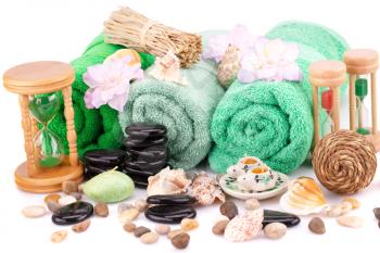 Spa set with towels, candles, shells, sandglass and stones isolated on white background.