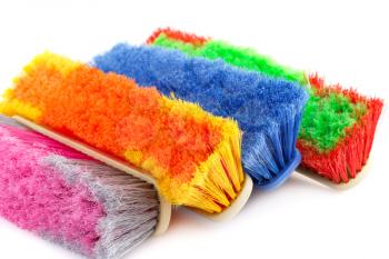 Colorful brooms isolated on white background.