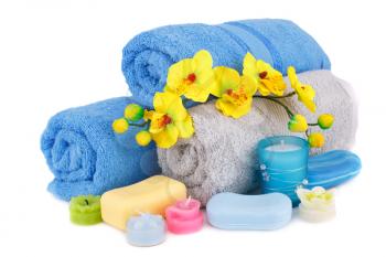 Spa set with towels, candles, soaps and flowers isolated on white background.