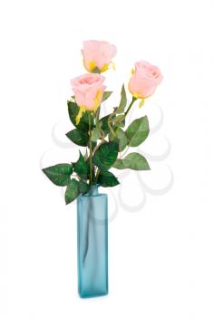 Pink fabric roses in blue vase isolated on white background.