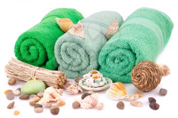Spa set with towels, candles, shells and stones isolated on white background.
