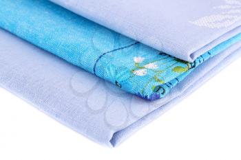 Stack of blue kitchen towels on white background.