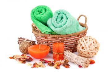 Spa set with towels, candles and dried flower isolated on white background.