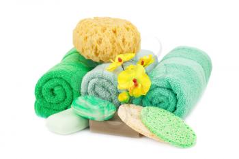 Spa set with towels, soaps, sponges and orchid flowers isolated on white background.