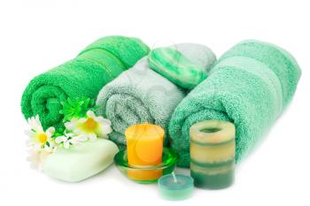 Spa set with towels, soaps, candles and flowers isolated on white background.