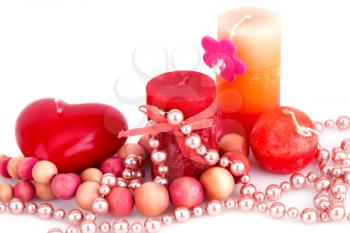 Colorful candles and necklaces on white background.